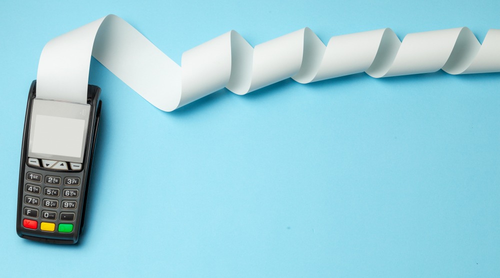 Machine for payments with a long roll of paper coming out of it